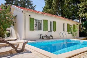 a villa with a swimming pool and a house at Mediterranean vacation home with pool Petrovac in Budva