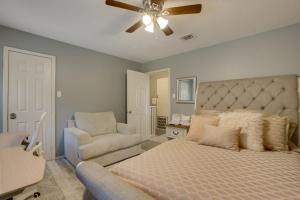 a bedroom with a bed and a chair and a ceiling fan at Pets Welcome! Humble Townhome 4 Mi to Airport in Humble