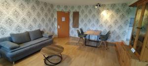 a living room with a couch and a table at Oberamer Hof in Bad Saulgau