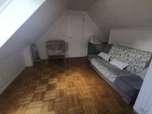 Habitación en el ático con cama y suelo de madera. en Maison indépendante bord de mer, en Moëlan-sur-Mer