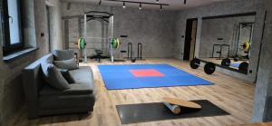 a living room with a couch and a gym at Alpine Chalet Krkonose in Prosečné