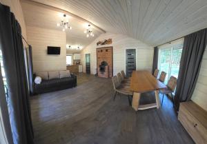 a living room with a table and a couch at Чорногірський двір in Dzembronya