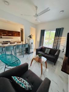 a living room with two couches and a kitchen at Almare F4 in Puerto Escondido