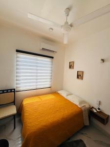 a bedroom with a yellow bed and a window at Almare F4 in Puerto Escondido +13 photos