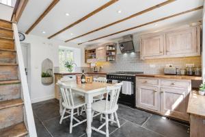 a kitchen with a table and chairs in it at Treovis Farm in Callington