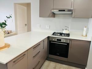 a kitchen with a stove and a counter top at 27D Homestead View in St Francis Bay