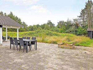 a table and chairs sitting on a patio at 10 person holiday home in Ålbæk-By Traum in Hedensted - Nordjylland +19 photos