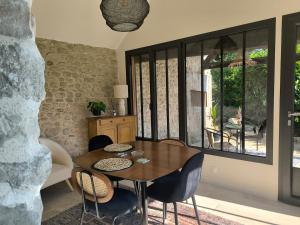 a dining room with a wooden table and chairs at Gite de charme avec piscine in Boissy-la-Rivière