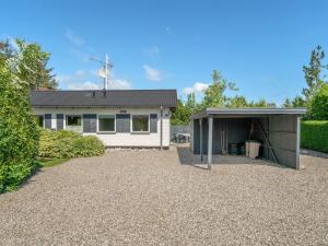a house with a garage in front of it at Holiday Home Suni - 400m from the sea by Interhome in Middelfart