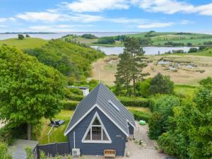 an aerial view of a small house with a view of a lake at Holiday Home Chayton - 450m from the sea by Interhome in Fåborg