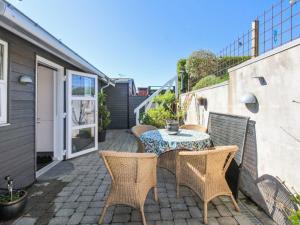 a patio with a table and chairs on a patio at Holiday Home Grim - 5m from the sea by Interhome in Brohave