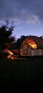 a large tent is lit up at night at Centro Turístico Epu Pillan Domo in Panguipulli +6 photos