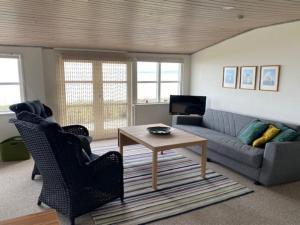 a living room with a couch and a table at Holiday Home Melia - 50m to the inlet by Interhome in Aabenraa