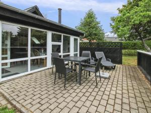 a patio with a table and chairs on it at Holiday Home Siouxsie - 500m from the sea by Interhome in Esbjerg