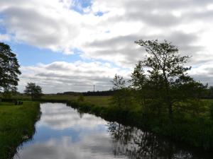 a river with trees and clouds in the sky at Holiday Home Josina - 32km from the sea by Interhome in Esbjerg