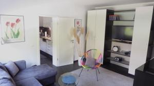 a living room with a couch and a chair at Ferienwohnung Sofie Marie in Oberhausen