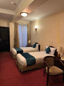 Postel nebo postele na pokoji v ubytování Platinum Hotel