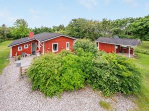 a red house with a porch and a yard at Holiday Home Anline - 900m to the inlet by Interhome in Tarm +17 photos