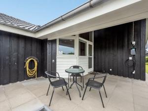 察姆Holiday Home Harth - 700m to the fjord by Interhome的庭院设有两把椅子、一张桌子和一扇窗户。
