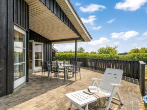 a patio with a table and chairs on a deck at Holiday Home Saara - 700m to the inlet by Interhome in Tarm
