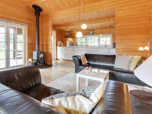 Una sala de estar con sofás de cuero y una mesa. en Holiday Home Ulvi - 300m to the inlet by Interhome, en Skjern