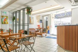 a restaurant with wooden tables and chairs and a room at Hôtel De La Gare Nantes Station Hotel Nantes in Nantes +31 photos