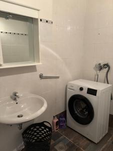 a bathroom with a washing machine and a sink at Rooms Marijeta in Skradin