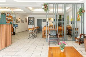 a restaurant with tables and chairs and a dining room at Hôtel De La Gare Nantes Station Hotel Nantes in Nantes