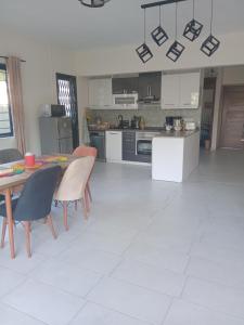 a kitchen with a table and chairs and a table and a kitchen at Mira lune villa in Flic-en-Flac