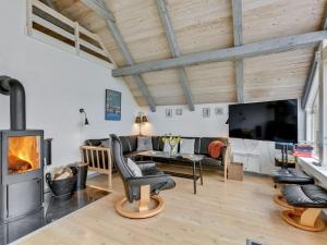 a living room with a couch and a fireplace at Holiday Home Gizella - 850m to the fjord by Interhome in Skjern
