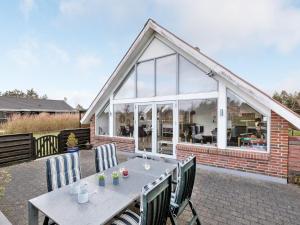 a patio with a table and chairs and a building at Holiday Home Gizella - 850m to the fjord by Interhome in Skjern +19 photos
