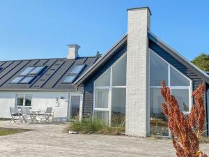 a house with large windows and a patio at Holiday Home Alkmar - 75m from the sea by Interhome in Thisted