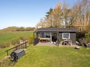 a small cabin in a field with a grass yard at Holiday Home Nielsen - 30m to the fjord by Interhome in Thisted