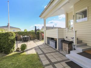 a house with a patio with a fireplace at Holiday Home Emmik - 150m from the sea by Interhome in Børkop +16 photos