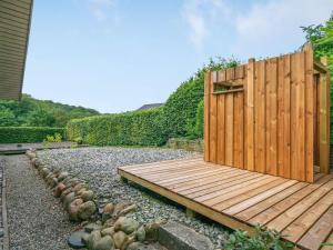 a wooden deck in a yard with a fence at Holiday Home Algot - 100m to the inlet by Interhome in Børkop
