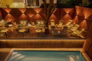 a patio with tables and chairs and a pool at Vincci Liberdade in Lisbon