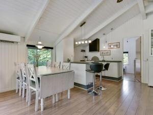 a kitchen and dining room with a table and chairs at Holiday Home Yngve - 56-5km from the sea by Interhome in Give