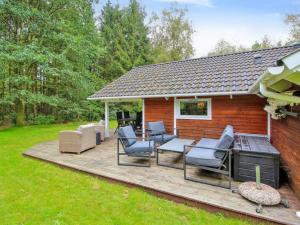 a wooden deck with chairs and a house at Holiday Home Ellica - 50km from the sea by Interhome in Give