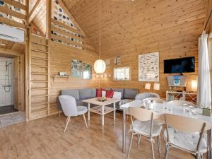 a dining room with a couch and a table and chairs at Holiday Home Terese - 45km from the sea by Interhome in Grindsted +20 photos