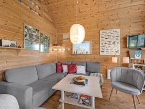a living room with a couch and a table at Holiday Home Terese - 45km from the sea by Interhome in Grindsted