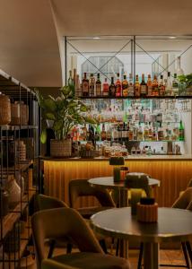 a restaurant with tables and chairs and a bar at Vincci Baixa in Lisbon
