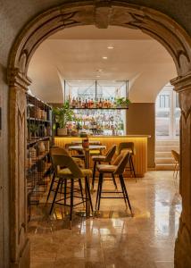 a restaurant with chairs and a table in a room at Vincci Baixa in Lisbon