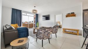 a living room with a couch and chairs at Namib Nook in Swakopmund