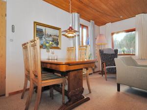 a dining room with a wooden table and chairs at Holiday Home Palle - 2km from the sea by Interhome in Snedsted +11 photos