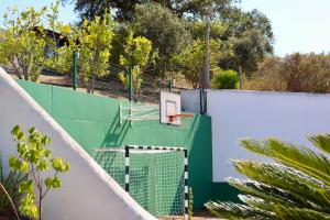a basketball hoop on top of a fence at Monte da Casa Telhada in Santiago do Cacém
