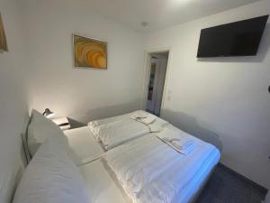 a hospital room with a bed and a flat screen tv at Fewo 2 EG Sylt Westerland in Süderende