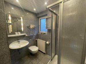 a bathroom with a sink and a toilet at Fewo 2 EG Sylt Westerland in Süderende