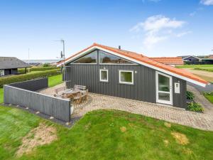 a gray house with an orange roof at Holiday Home Malila - 400m to the fjord by Interhome in Vinderup +24 photos