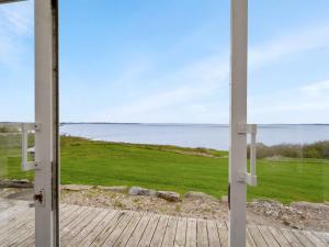 an open door to a view of the water at Holiday Home Thorge - 75m to the inlet by Interhome in Struer