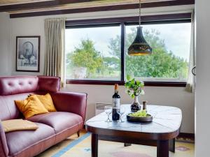 een woonkamer met een bank en een tafel bij Holiday Home Leocadia - 150m to the fjord by Interhome in Øsløs